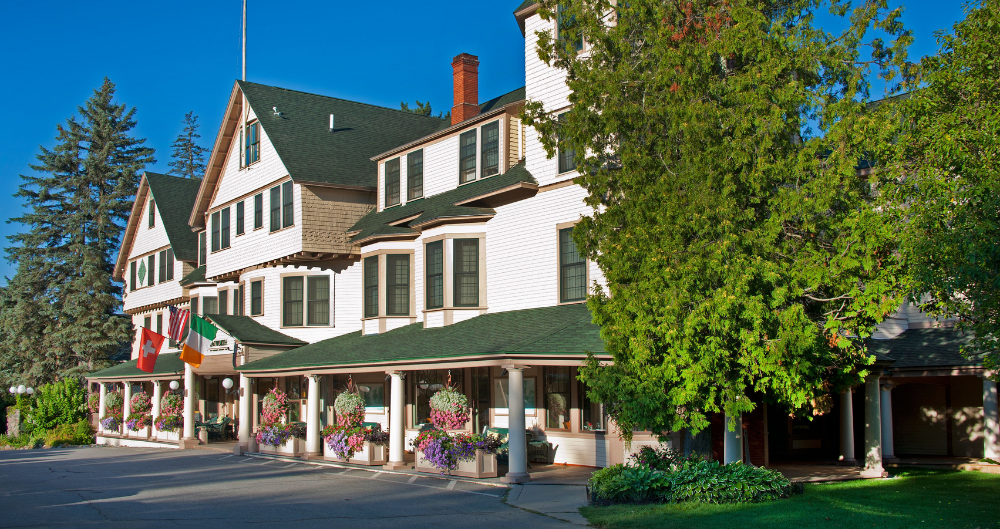 The Wentworth inn with trees and hanging flower plants.