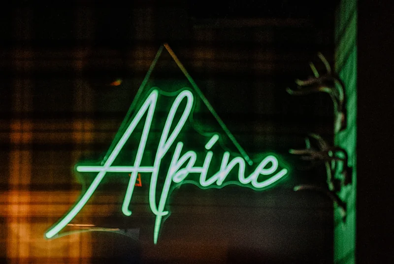 Green neon sign of the Alpine at the Wentworth