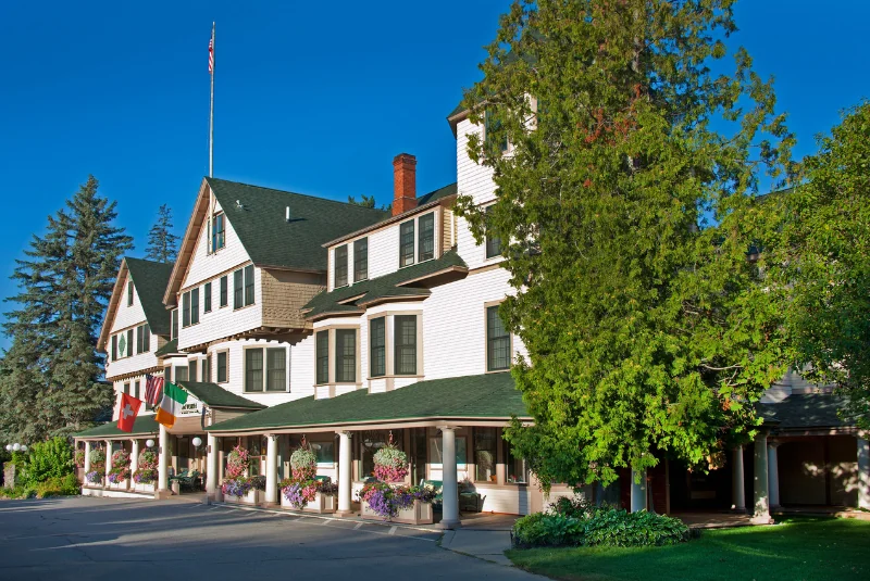 The Wentworth inn with trees and hanging flower plants.