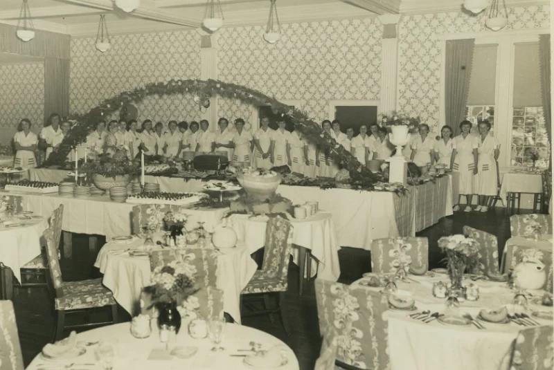 A black and white photo of a group of women at a catering event at the Wentworth