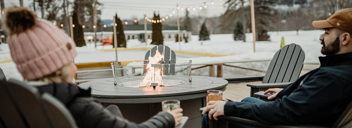 couple sitting outside at firepit